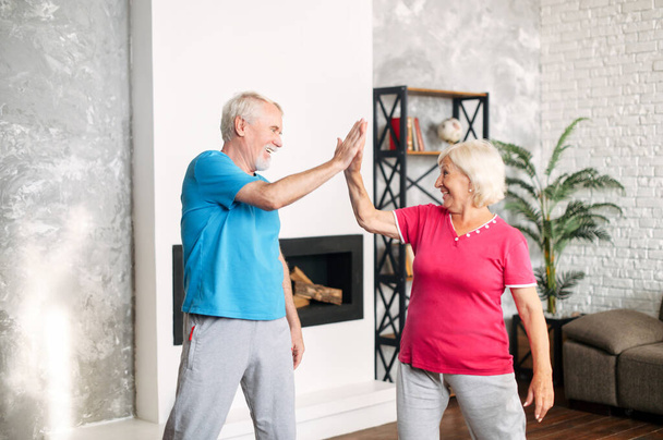 Senior couple doing sports at home - Foto, afbeelding