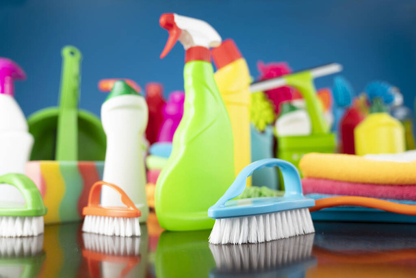 Házi és irodai takarítás téma. Színes tisztító készlet kék háttér. - Fotó, kép