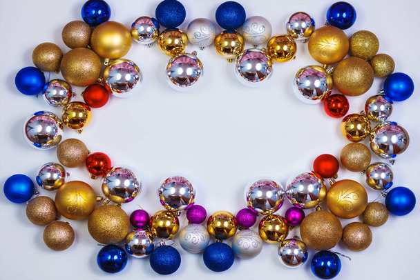 Gold, blue, red and silver glitter Christmas balls pattern. Flat lay, top view, copy space. Christmas golden,red,violet, blue and silver balls decorations on white background. New year creative arrangement frame. - Φωτογραφία, εικόνα