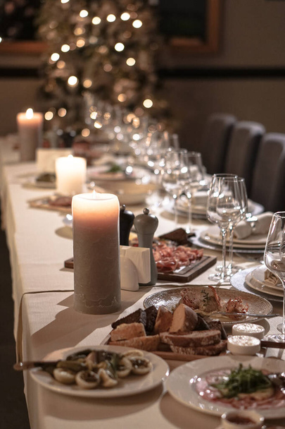 Nicely served New Year's table in the restaurant. Christmas night in a cafe or at home. Stock photo for design - Photo, Image