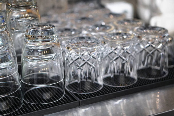 Clean washed glasses of dishes in the kitchen. Glasses for a large company - Fotó, kép