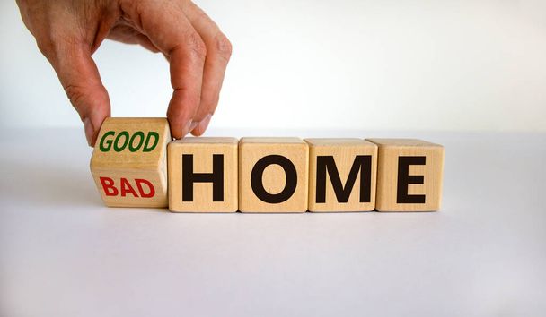 Bad home or good home. Hand turns a cube and changes the words 'bad home' to 'good home'. Beautiful white background. Business and good home concept, copy space. - Zdjęcie, obraz
