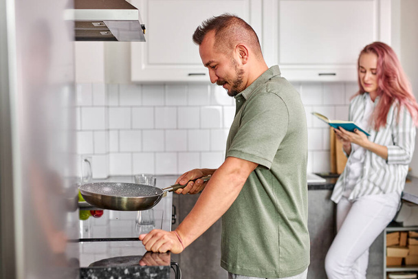 man cooking in the morning, couple enjoying spending time together - Photo, Image