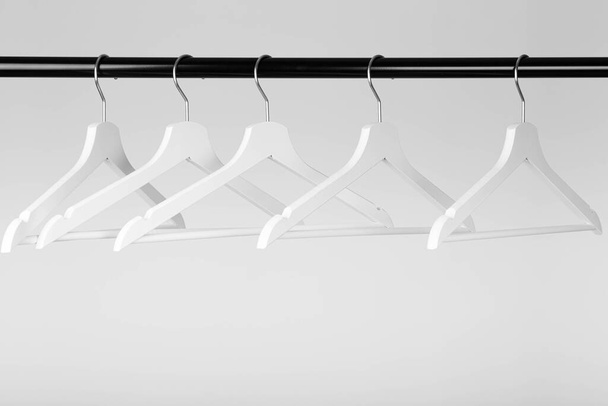 black fashion coat rack with empty white hangers. High quality photo - Zdjęcie, obraz