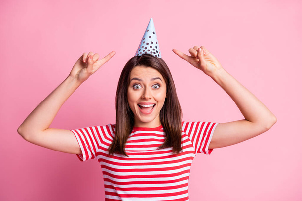Photo portrait of cheerful funny girl pointing with fingers on birthday cap smiling isolated on pastel pink color background - Φωτογραφία, εικόνα