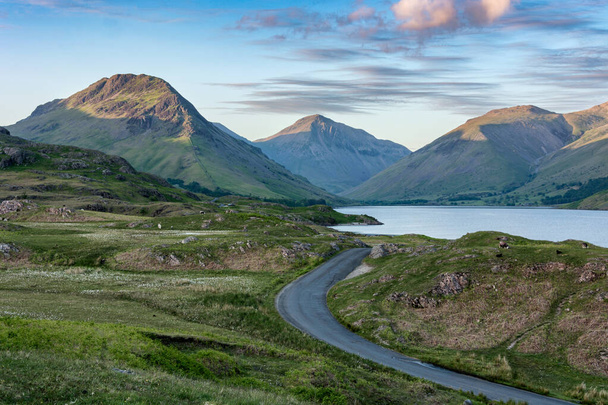 Beautiful scenic view of Wastwater in the English Lake District with dramatic clouds and country road. - Photo, Image