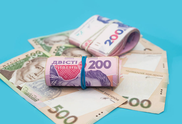 Ukrainian hryvnia on a blue background. Banknotes of 200 and 500 hryvnia. Financial concept. - Photo, Image