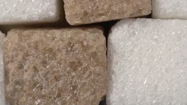 Rotación del primer plano del azúcar. Azúcar blanco y moreno. Cubos de azúcar. - Metraje, vídeo