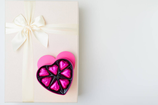 Merry Christmas. flat lay with pink heart shaped candy box and present box on white background. - Fotoğraf, Görsel