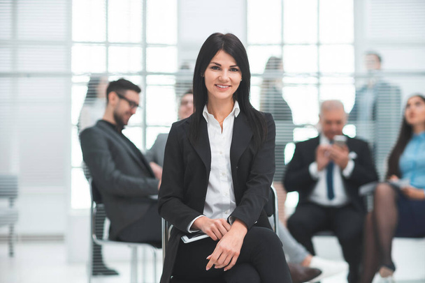confident young business woman sitting in a modern office - Foto, imagen