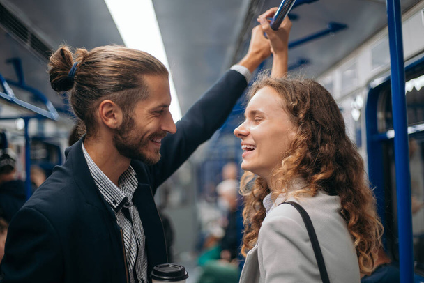 happy couple standing in a subway train. - Φωτογραφία, εικόνα