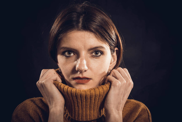 Studio portrait of young beautiful woman dressed in sweater - Photo, image