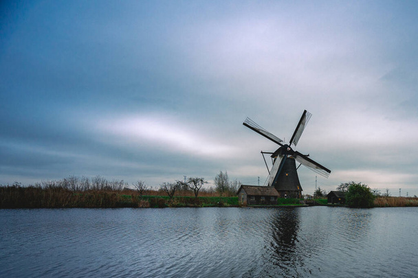 Ολλανδικό τοπίο με σύννεφα και ανεμόμυλους στην τουριστική περιοχή Kinderdijk, Ολλανδία - Φωτογραφία, εικόνα