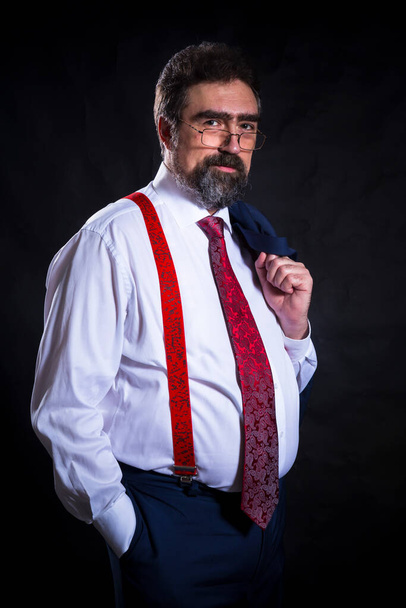 Mature businessman dressed in blue suit with red tie studio portrait. - Fotoğraf, Görsel