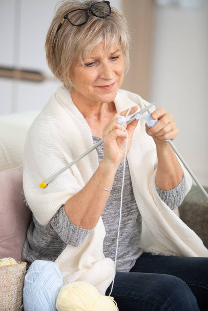 senior woman enjoying her retirement time and knitting - Fotografie, Obrázek