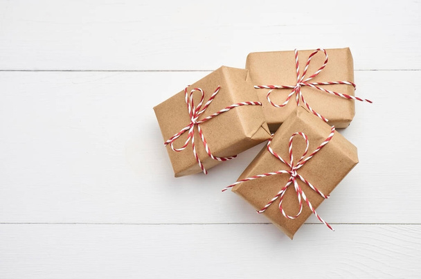 Christmas gift boxes on white wooden background - Fotó, kép