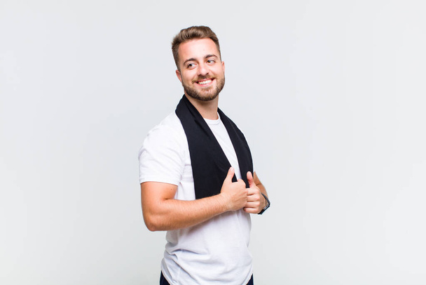 European young man with towel on white background - Foto, Imagem