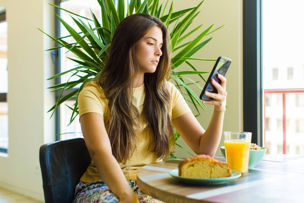 young pretty woman having breakfast at home - Fotó, kép