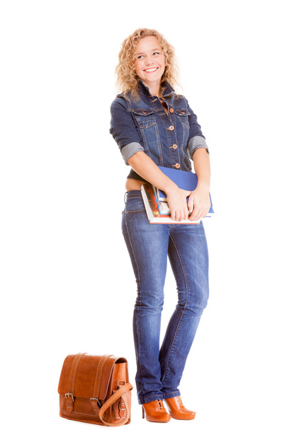 Denim fashion. Full length student girl in blue jeans bag books - 写真・画像