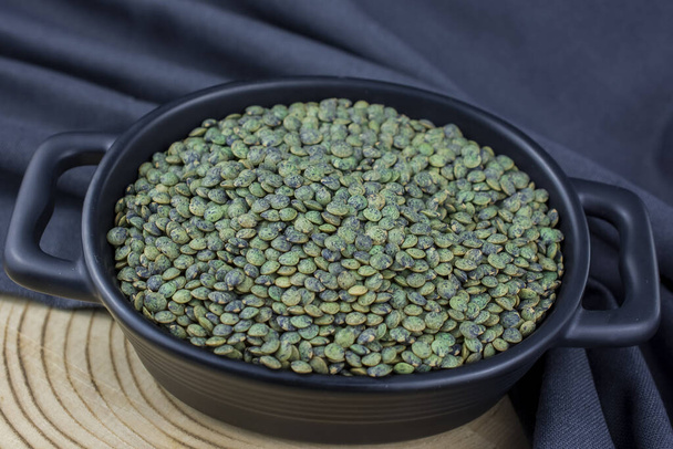 Bowl of green  turkish lentils on wooden background - Photo, Image
