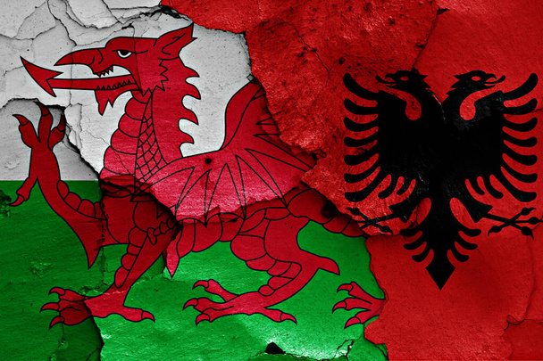 flags of Wales and Albania painted on cracked wall - Photo, Image