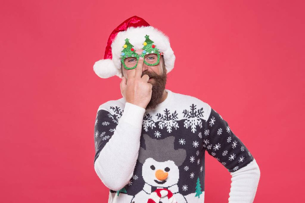 bearded man in sweater for celebration. show middle finger. prepare for xmas party. winter holiday fun. christmas tree decoration. shopping and sales concept. happy new year. merry christmas - Photo, image