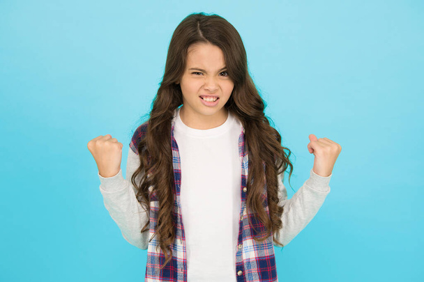 Inner energy. Little girl flex arms blue background. Small girl with long hair show strength. Fitness. Beauty and health. Childhood and girlhood. Feminism concept. Future is female. Strong girl - Photo, Image