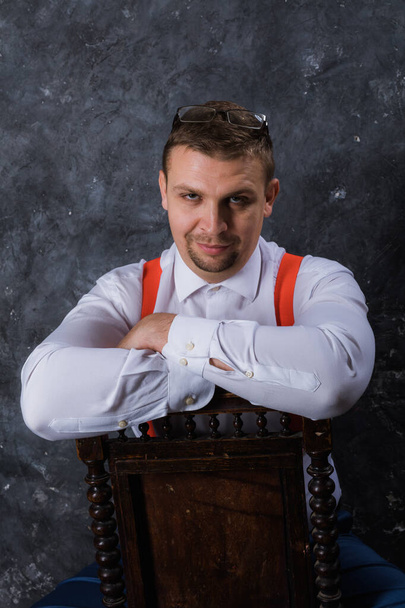 Mature businessman dressed in whire shirt with red suspenders studio portrait. - Foto, immagini