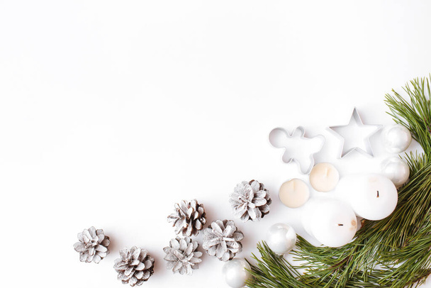 Christmas, winter, new year composition. Fir tree branches, pine cone, candles on white background. Flat lay, top view, copy space - Photo, image