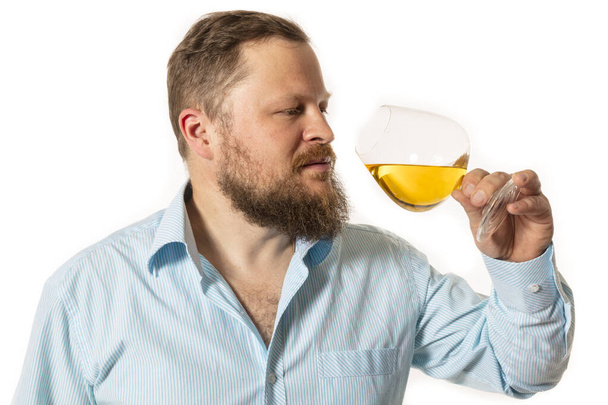 Solid bearded man in shirt tasting whisky studio portrait - Foto, Imagen
