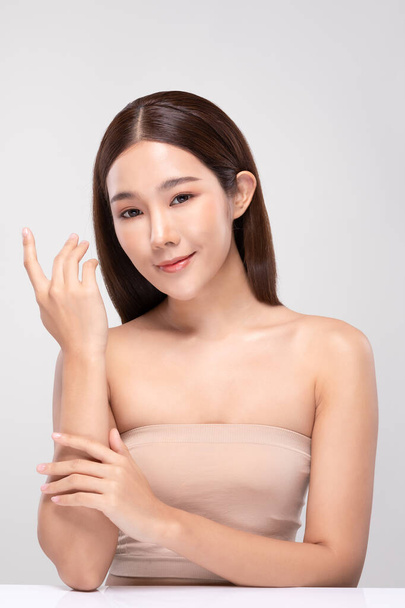 Beautiful Asian young woman holding hands smile with clean and fresh skin Happiness and cheerful with positive emotional,isolated on gray background,Beauty and Cosmetics Concept - Foto, afbeelding