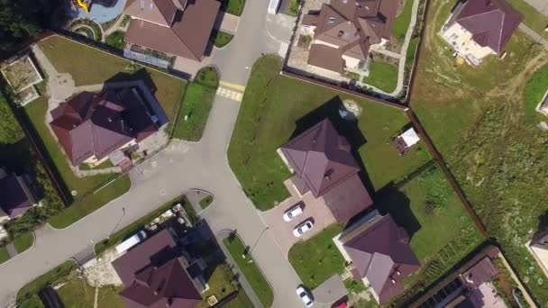 Top down Aerial drone footage over the summer street. Modern luxury houses. Aerial flying over the residential area. Asphalt roads and sidewalks - Footage, Video