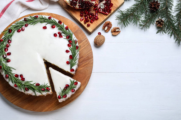 Flat lay composition with traditional Christmas cake on white wooden table. Space for text - Fotó, kép