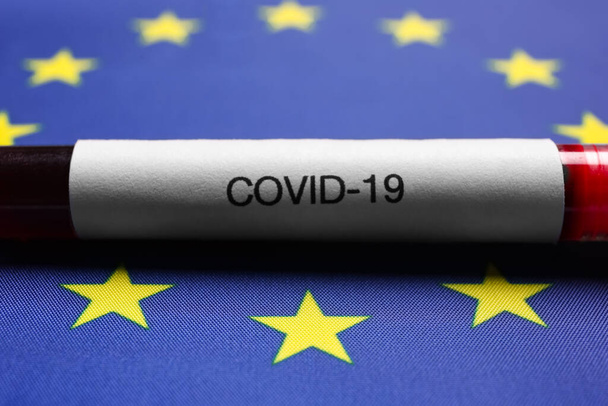 Test tube with blood sample on European Union flag background, closeup. Coronavirus outbreak - Foto, imagen