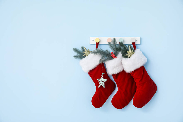 Beautiful Christmas socks hanging on color wall - Photo, Image