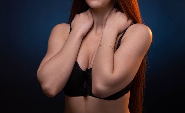 Shot of young woman with hands on black bra - Photo, Image