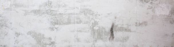 Gray concrete wall peeled of wallpaper. Concrete background. Banner. - 写真・画像