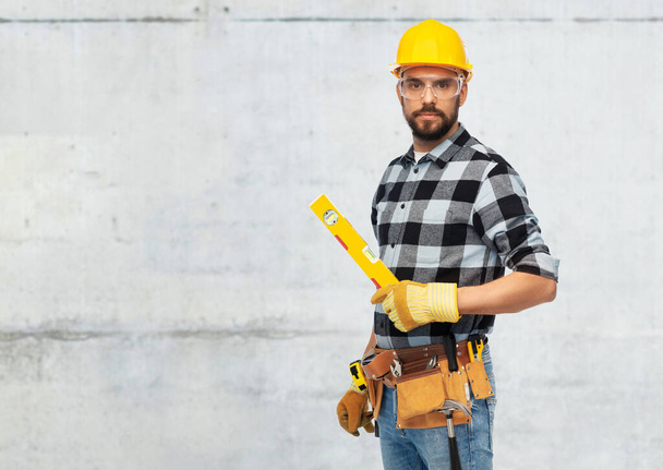 male worker or builder in helmet with level - Φωτογραφία, εικόνα