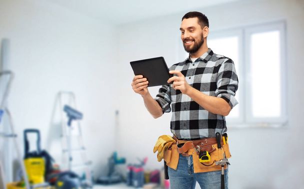 happy builder with tablet computer and tools - Foto, Imagen