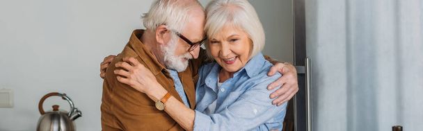 cheerful senior couple hugging indoors, banner - Foto, Imagem