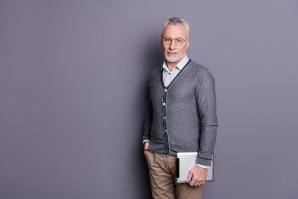 Portrait of his he nice-looking attractive calm content intellectual business shark wearing casual formal-wear carrying digital e-book isolated over gray pastel background - Foto, immagini