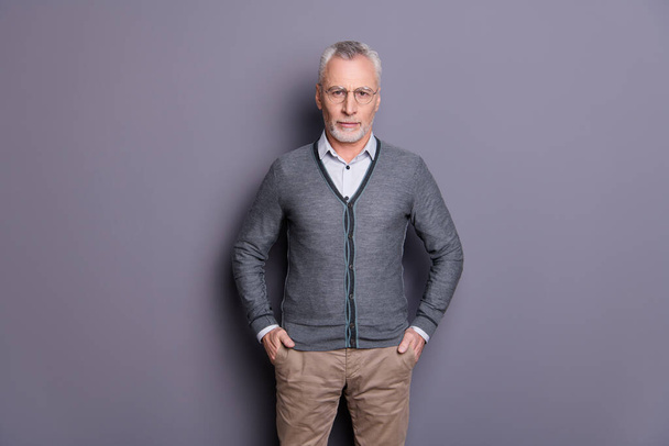 Portrait of his he nice-looking attractive calm content business shark wearing casual formal-wear holding hands in pockets isolated over gray pastel background - Φωτογραφία, εικόνα