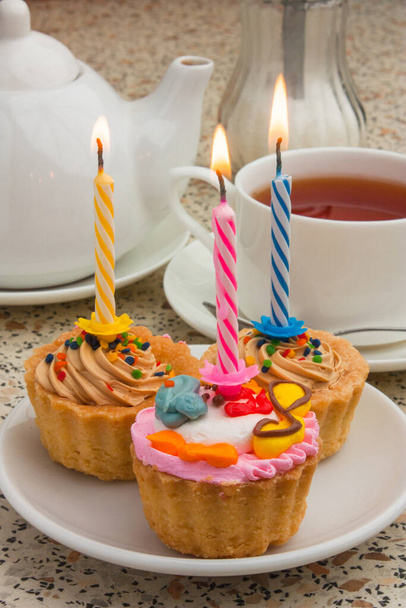 cake with a candle and tea drinking - Foto, imagen