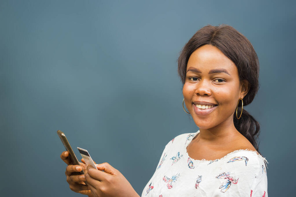 A closeup shot of a beautiful young African lady using her phone - Photo, image