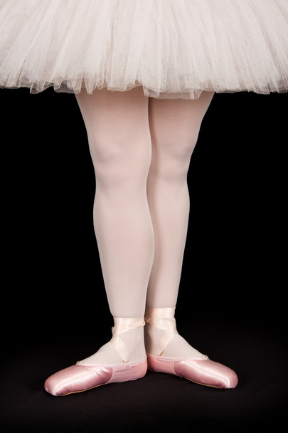 Ballet dancer standing on black floor while dancing artistic con - Foto, imagen