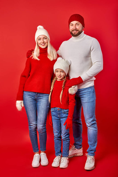 portrait of young parents with daughter in winter clothes - Foto, Imagen