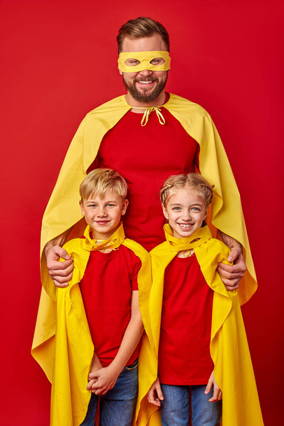 kind responsible father with children pretend to be superhero - 写真・画像