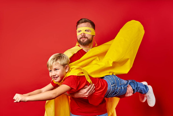 happy dad and kid boy play superhero game, imitate flight - 写真・画像
