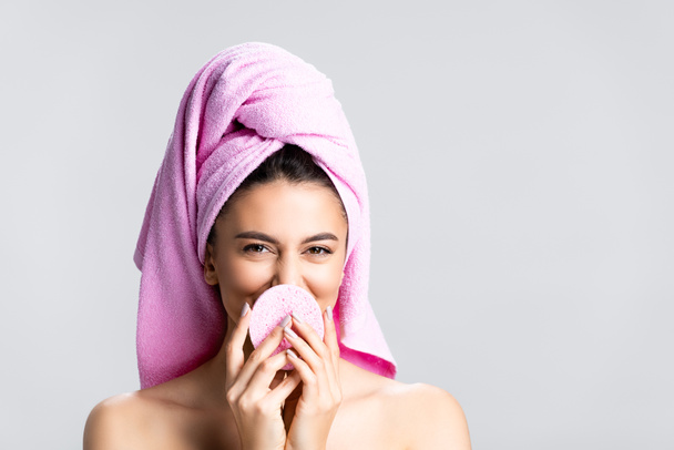smiling beautiful woman with towel on hair and sponge isolated on grey - Photo, image