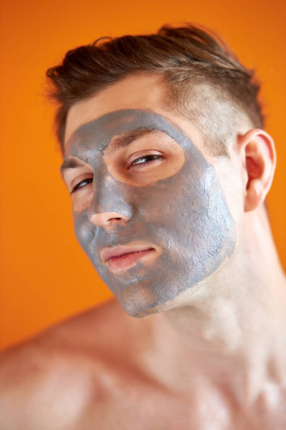 handsome young shirtless guy with cosmetic peel mask on face - Φωτογραφία, εικόνα